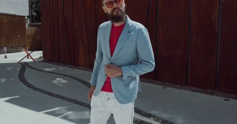 A young bearded hipster, looking around and walking Stock Footage 142164589