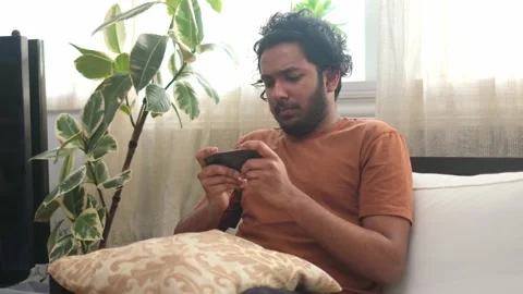 Young bearded indian is playing game losing the competition and feeling mad. Stock Footage 151890995