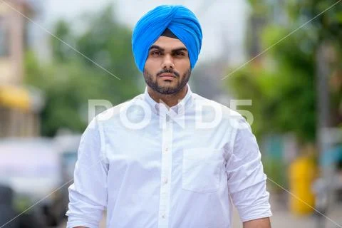 Young bearded Indian Sikh man wearing turban outdoors Stock Photos