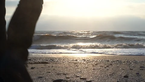 Young bearded man in black clothes is walking along the beach at the sunny day. Stock Footage 127255504