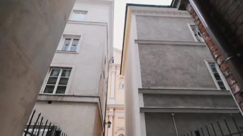 Young bearded man in a black coat walking streets of old city. Warsaw, Poland Video stock 132301588