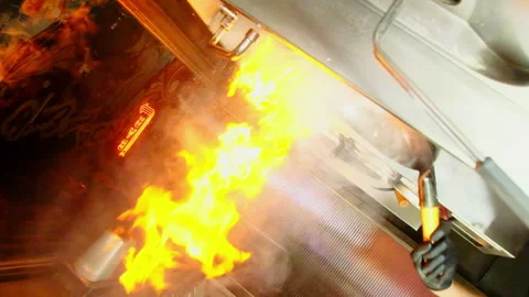 Young bearded man chef cooks food in wok with open flame Stock Footage 324807564