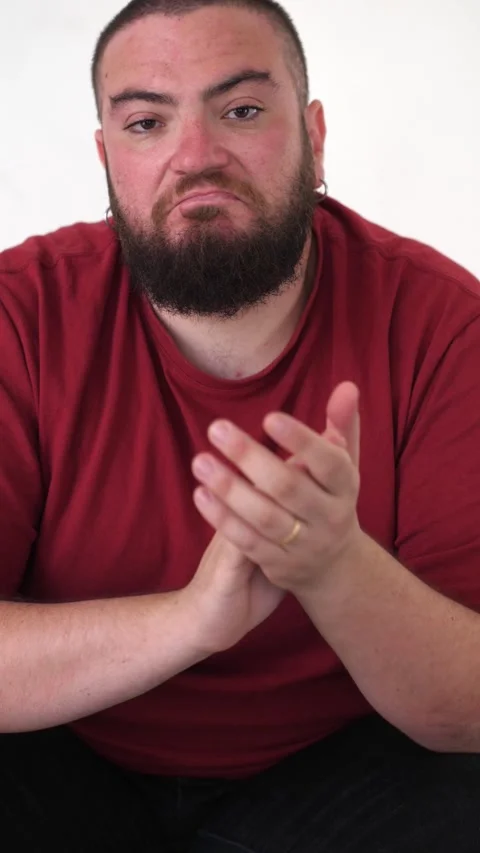 Young bearded man claps ironically to mock someone Stock Footage 289003422