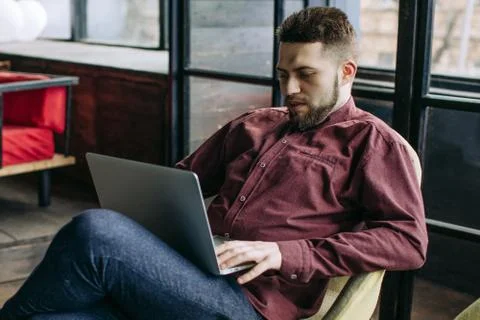 Young bearded man communicates over the internet Stock Photos