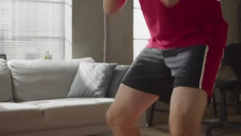 Young bearded man doing squats exercises, sports training alone Stock Footage 169017122
