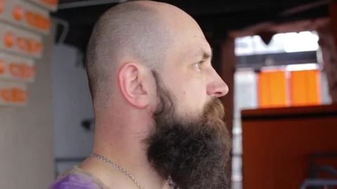 Young bearded man doing workout. Man tilts head to side stretching neck. 1080p Stock Footage 77801444