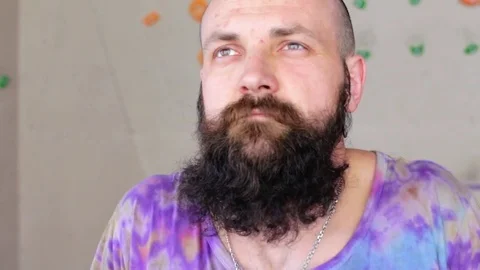 Young bearded man doing workout. Man stretches shoulders. 1080p cinematic HD Stock Footage 77801540