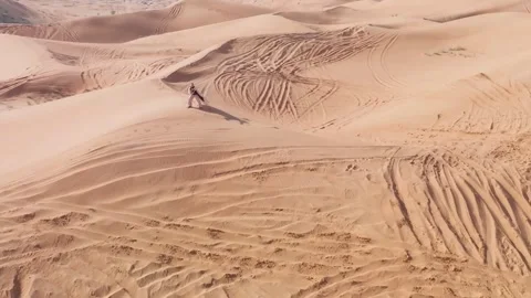 Young bearded man dressed as a shaman dancing on desert sand Stock Footage 249586134