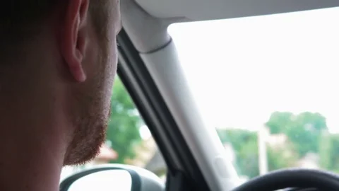 Young bearded man driving car on road. Shallow depth of field. 4k UHD video Stock Footage 77769494