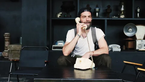 Young bearded man enjoying a retro telephone call 库存影片 341963862