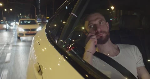 Young bearded man is having a call on his cellphonewhile he is traveling by Stock Footage 195243771