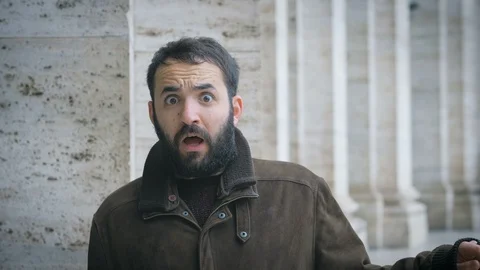 Young bearded man looking around and getting scared looking at camera.Fear,shock Stockbeeldmateriaal 113408445