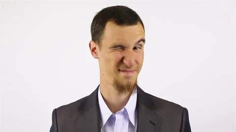 Young bearded man looking at camera and winks Stock Footage 92443750