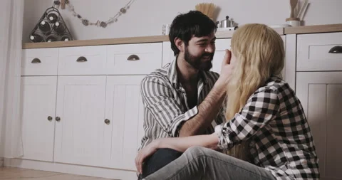 Young bearded man looking with love at pretty young white hearted woman Video stock 148895584