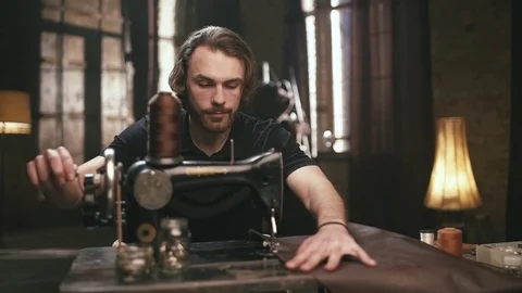 The young, bearded man, makes leather goods Stock Footage 71626681