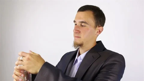 Young bearded man opens a bottle and drink water Stockbeeldmateriaal 92508000