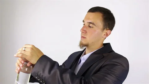 Young bearded man opens a bottle and drink water Stockbeeldmateriaal 92508015