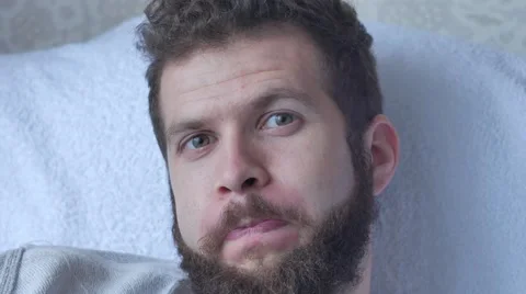A young bearded man poses a face showing tongue hamming smiling and laughing Video stock 68880578