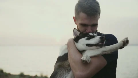 Young bearded man posing on the camera with his dog Stock Footage 159676398