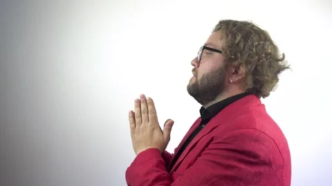 A young bearded man prays, asking God for help. Stock Footage 137022716