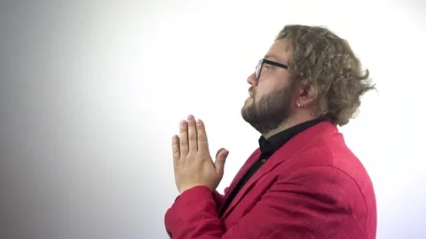 A young bearded man prays, asking God for help. Video stock 137045755