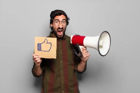 Young bearded man protesting with a megaphone Stock Photos