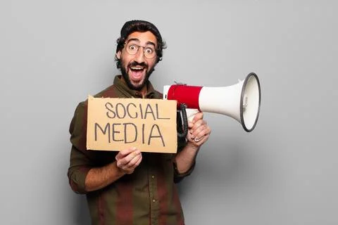 Young bearded man protesting with a megaphone Stock Photos