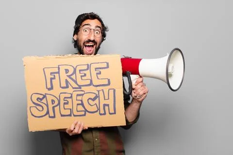 Young bearded man protesting with a megaphone Stock Photos