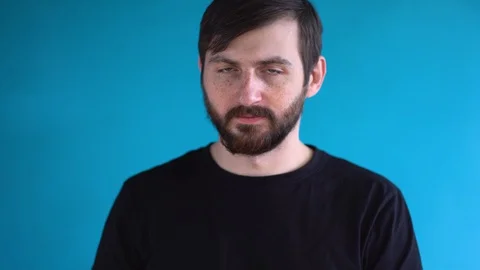 Young bearded man put on two protective medical gloves on his hands. Lock down. Stock Footage 129979229