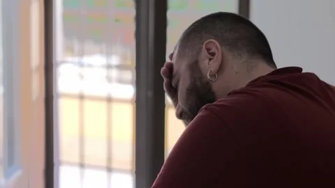 Young bearded man seen from behind in despair Stock Footage 289003569