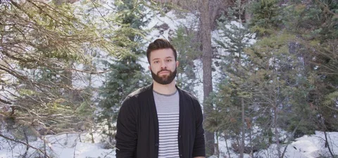 Young Bearded Man Standing in Forest looking at Camera Stock Footage 87265899