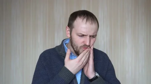Young bearded man suffering from toothache desperate and stressed because pain Stock Footage 103121001