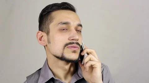 Young bearded man talking on the phone Video stock 73686398