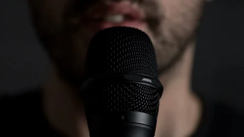 Young bearded Man Talks To Microphone. Man microphone speech, front view Stock Footage 126288683