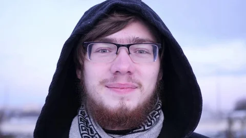 Young bearded man thinking about something and touching his beard Video stock 83369013