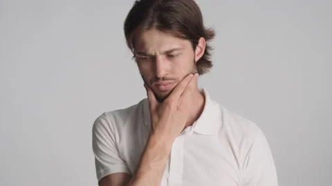 Young bearded man thinking and happily showing new idea Stock Footage 135907936