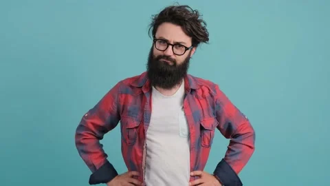 Young bearded man on turquoise background showing thumb down gesture at camera. Stock Footage 139646227