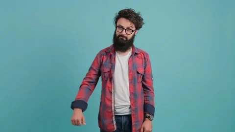 Young bearded man on turquoise background showing thumb down gesture at camera. Stock Footage 140335163
