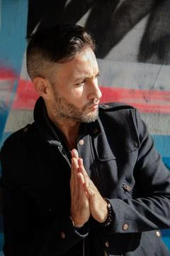 A young bearded man using the cell phone in the city Stock Photos