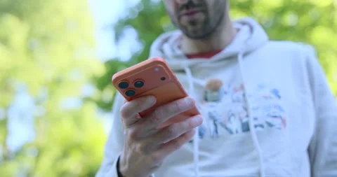 Young bearded man using his smartphone outdoors Stock Footage 345021927
