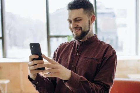 Young bearded man using mobile phone Stock Photos