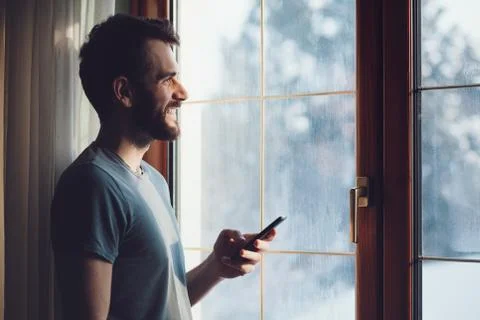Young bearded man using a smartphone Stock Photos