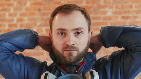 Young bearded man wearing protective workwear, mask and glasses. Close up Stock Footage 112957639
