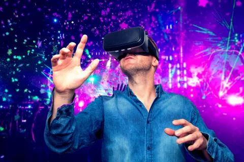 Young bearded man wearing virtual reality glasses in modern interior design c Stock Photos