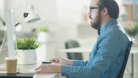 Young Bearded Man Working on Personal Computer. Video stock 70629474