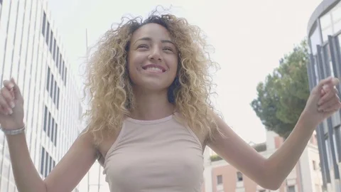 Young beautiful and curly woman celebrating jumping and smiling Stock Footage