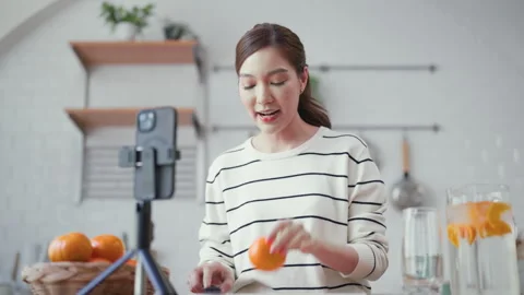 Young beautiful asian content creator recording a video or live streaming Stock Footage 325542135