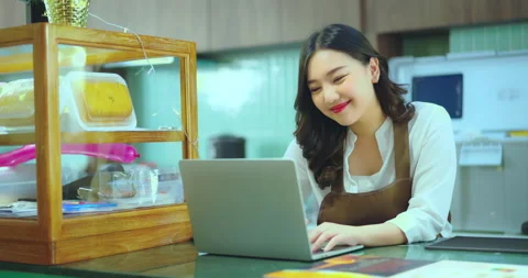 Young beautiful asian using computer at counter bar. Video stock 258840654