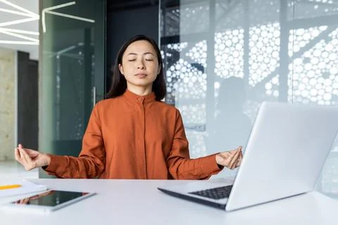 Young beautiful Asian web developer working inside office building, woman Stock Photos