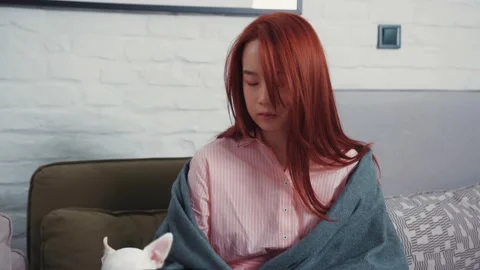 Young beautiful Asian woman suffering symptoms of flu sneezing allergy while Stock Footage 131668085